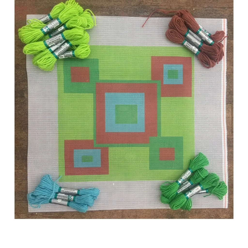Needlepoint kit with a pre-printed geometric pattern canvas, surrounded by colorful Appletons  threads.