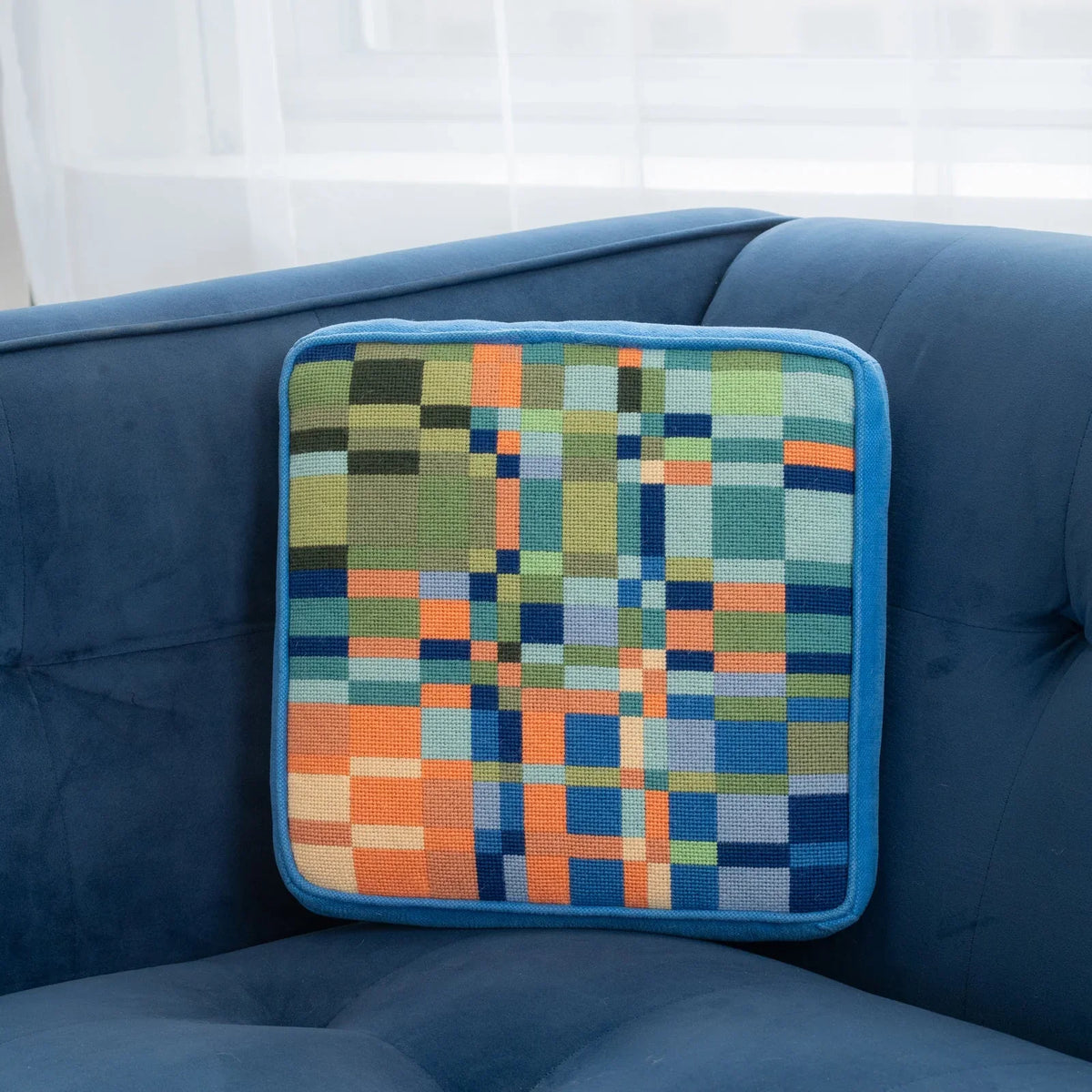 A colorful geometric patterned needlepointed cushion. Designed and sold by Daisy’s Needlepoint Kits.