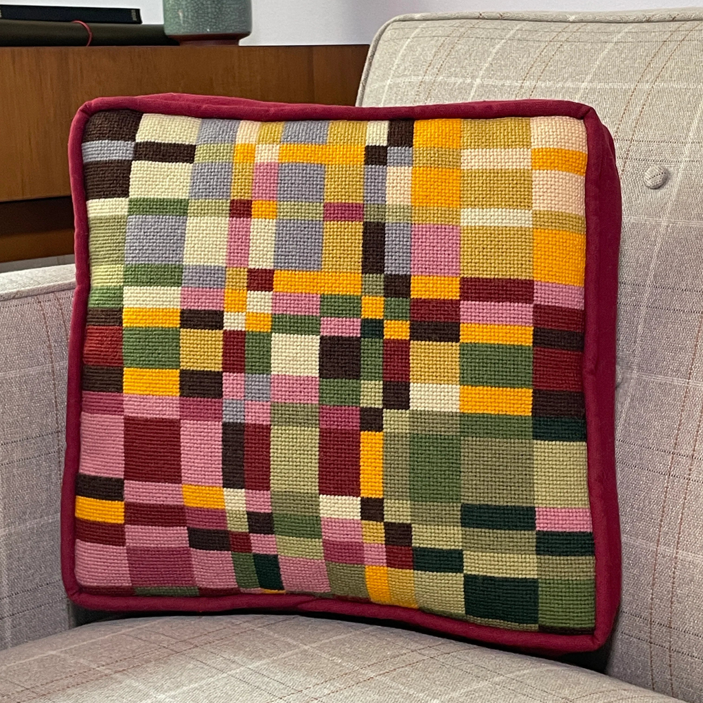 A colorful patterned needlepointed cushion. Designed and sold by Daisy’s Needlepoint Kits.