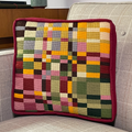 A colorful patterned needlepointed cushion. Designed and sold by Daisy’s Needlepoint Kits.